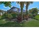 Gorgeous screened-in lanai overlooking a lush, private backyard with beautiful tropical landscaping at 13841 Campoleone St, Venice, FL 34293