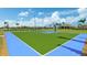 Bright community basketball court with blue and green surface, surrounded by manicured landscaping at 13841 Campoleone St, Venice, FL 34293