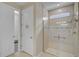Updated bathroom featuring a glass shower, decorative tile and a doorway to a walk in closet at 13841 Campoleone St, Venice, FL 34293