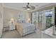 Well-lit bedroom featuring a ceiling fan, neutral walls, and large windows providing ample natural light at 13841 Campoleone St, Venice, FL 34293