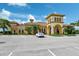 Beautiful community clubhouse with stucco architecture, landscaping, and ample parking on a sunny day at 13841 Campoleone St, Venice, FL 34293