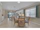Dining area with tiled floors next to the modern kitchen and access to the backyard patio at 13841 Campoleone St, Venice, FL 34293