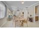 Dining area featuring tile floors, neutral paint, and a view into the living room at 13841 Campoleone St, Venice, FL 34293