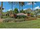 Beautiful IslandWalk community entrance sign surrounded by lush landscaping and palm trees at 13841 Campoleone St, Venice, FL 34293