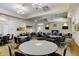 The game room features tables, chairs, and entertainment options, perfect for social gatherings at 13841 Campoleone St, Venice, FL 34293