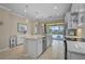 Open kitchen features a large island, stainless appliances, and sliding glass doors to the pool and lanai at 13841 Campoleone St, Venice, FL 34293