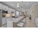 Spacious open kitchen with stone countertops, stainless appliances, and seating at the island counter at 13841 Campoleone St, Venice, FL 34293