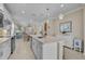 Bright, open kitchen includes an island and seamless flow into the dining and living areas for easy entertaining at 13841 Campoleone St, Venice, FL 34293