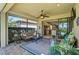 Covered and screened lanai features comfortable seating, a ceiling fan, and views of the pool at 13841 Campoleone St, Venice, FL 34293