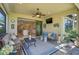 Relaxing lanai features comfortable seating and views of the kitchen through sliding glass doors at 13841 Campoleone St, Venice, FL 34293