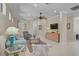 Spacious living room featuring tile floors, neutral paint, and large archways to other rooms at 13841 Campoleone St, Venice, FL 34293