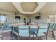 The spacious outdoor bar area has ample seating, multiple TVs, and ceiling fans for a relaxing experience at 13841 Campoleone St, Venice, FL 34293