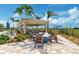 Outdoor community lounge area featuring a covered pavilion, fireplace, tables and chairs at 13841 Campoleone St, Venice, FL 34293