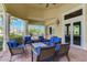 Inviting outdoor patio featuring comfortable seating, a ceiling fan, and nice view to the exterior of the property at 13841 Campoleone St, Venice, FL 34293