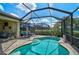 Relaxing pool area with brick paving, screened enclosure, and seamless access to the covered lanai at 13841 Campoleone St, Venice, FL 34293