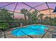 Inviting private pool surrounded by lush landscaping and an enclosed screened lanai for relaxing outdoor living at 13841 Campoleone St, Venice, FL 34293