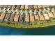 An aerial view showcases a waterfront community with houses, pools, and lush greenery at 13871 Miranese St, Venice, FL 34293