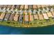 Aerial view of waterfront home with pool surrounded by similar homes in a planned community at 13871 Miranese St, Venice, FL 34293