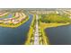 Aerial view of a community highlighting waterways, greenery, and single-Gathering homes at 13871 Miranese St, Venice, FL 34293