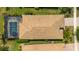 A drone view highlights the backyard pool, house roof and landscaping at 13871 Miranese St, Venice, FL 34293