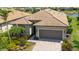 Beautiful single-Gathering home showcasing a well-maintained yard, stylish roof, and two-car garage at 13871 Miranese St, Venice, FL 34293
