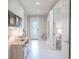 Bright and airy hallway featuring stylish decor and an elegant entry door at 13871 Miranese St, Venice, FL 34293