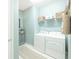 Bright laundry room features a washer, dryer, storage shelf, and cabinet with plant at 13871 Miranese St, Venice, FL 34293