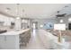 Bright, open-concept living area showcases kitchen with island, modern lighting and flows into the living room at 13871 Miranese St, Venice, FL 34293