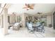 This is a covered patio with neutral toned colors, a dining table, and ceiling fans at 13871 Miranese St, Venice, FL 34293
