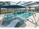 Beautiful pool with a spa and lovely water feature overlooking the serene lake at 13871 Miranese St, Venice, FL 34293