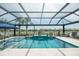 Gorgeous screened-in pool and spa with lake view and spacious deck area at 13871 Miranese St, Venice, FL 34293