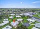 Aerial view of a community near a waterfront with lush greenery and well-maintained lawns at 16 Oakwood N Dr # 16, Englewood, FL 34223