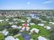 Sprawling community view featuring lush landscaping, waterfront access, and serene residential streets at 16 Oakwood N Dr # 16, Englewood, FL 34223
