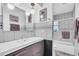 Contemporary bathroom featuring stylish lighting, modern fixtures, and a shower-tub combo at 16 Oakwood N Dr # 16, Englewood, FL 34223