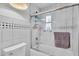Clean bathroom with a tub, shower, and decorative tile accent at 16 Oakwood N Dr # 16, Englewood, FL 34223