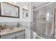 Well-lit bathroom with a glass-enclosed shower, decorative tile, and stylish vanity at 16 Oakwood N Dr # 16, Englewood, FL 34223