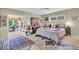 Inviting bedroom with decorative rug, comfortable bed, and sliding doors to outdoor space at 16 Oakwood N Dr # 16, Englewood, FL 34223