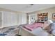 Bright bedroom featuring a plush bed, patterned rug, and ample closet space at 16 Oakwood N Dr # 16, Englewood, FL 34223