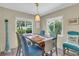 Cozy dining area featuring wooden table with colorful seating and bright natural lighting at 16 Oakwood N Dr # 16, Englewood, FL 34223