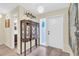 Inviting entryway with tile flooring, decorative display case, and a brightly lit front door, creating a warm welcome at 16 Oakwood N Dr # 16, Englewood, FL 34223