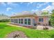 Rear exterior view of a home with a patio and well-maintained lawn at 16 Oakwood N Dr # 16, Englewood, FL 34223