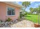 Charming home exterior with well-manicured landscaping and a mature palm tree at 16 Oakwood N Dr # 16, Englewood, FL 34223