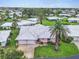 Charming home with a tile roof, manicured lawn, and a convenient two-car garage at 16 Oakwood N Dr # 16, Englewood, FL 34223
