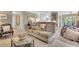 Comfortable living room view with sofa, patterned area rug, and access to the kitchen at 16 Oakwood N Dr # 16, Englewood, FL 34223