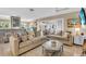 Spacious living room featuring plush seating, decorative accents, and seamless indoor-outdoor flow at 16 Oakwood N Dr # 16, Englewood, FL 34223