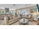 Spacious living room featuring plush seating, decorative accents, and seamless indoor-outdoor flow at 16 Oakwood N Dr # 16, Englewood, FL 34223
