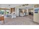 Inviting living room featuring cozy seating, artistic decor, and seamless transition to adjoining room at 16 Oakwood N Dr # 16, Englewood, FL 34223
