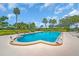 Inviting community pool surrounded by lush greenery and ample lounging space at 16 Oakwood N Dr # 16, Englewood, FL 34223