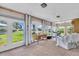 Bright sunroom with large windows, perfect for a home office or cozy reading nook with views of the well-maintained yard at 16 Oakwood N Dr # 16, Englewood, FL 34223