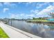 Scenic waterfront view featuring docks, boats, and lush landscaping along the shoreline at 16 Oakwood N Dr # 16, Englewood, FL 34223